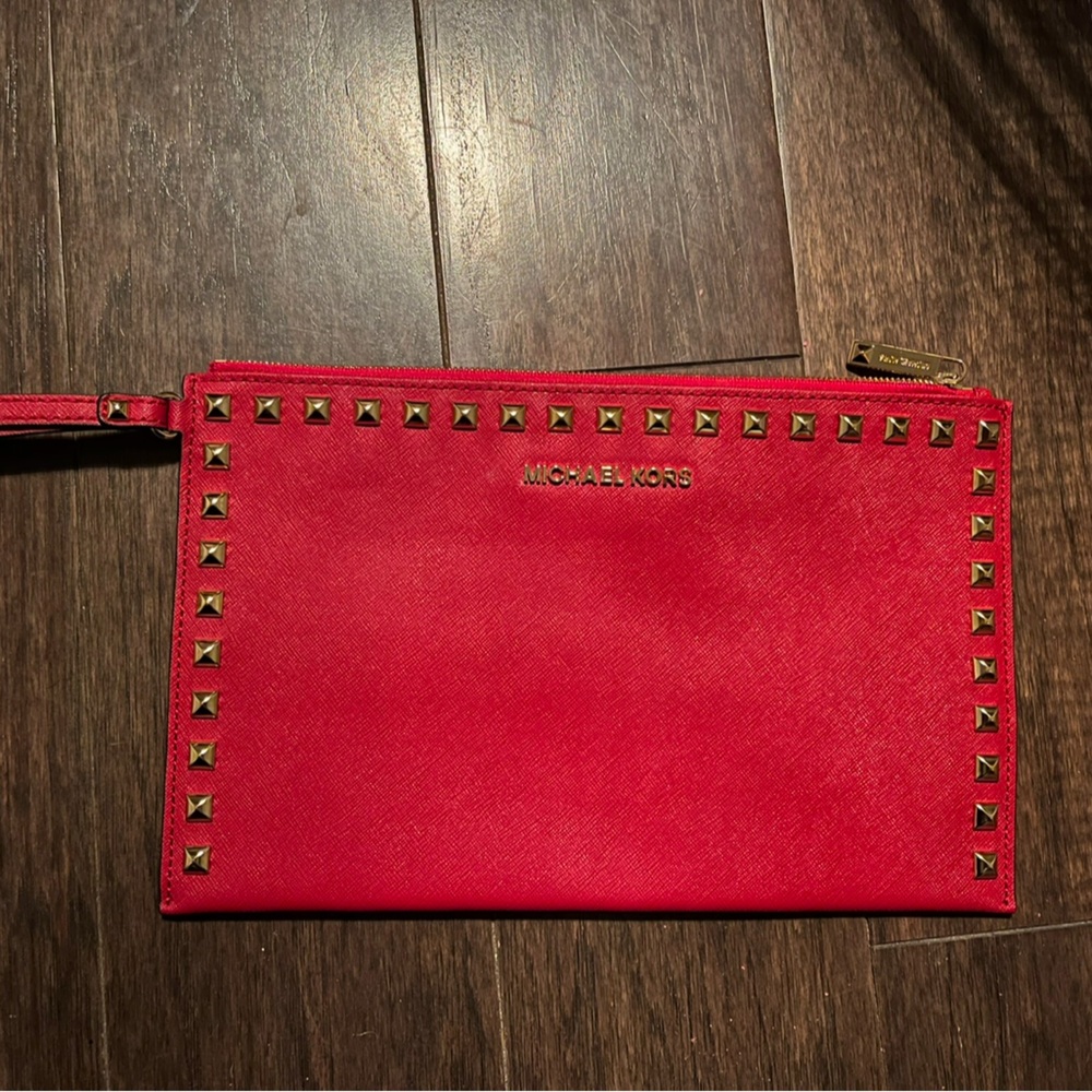 Michael Kors red wristlet with gold studded hardware.